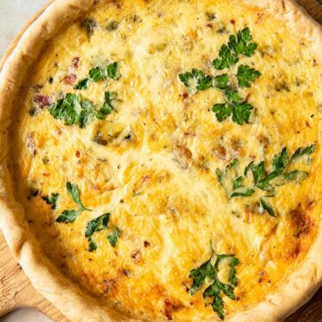 top down view of quiche on a round cutting board