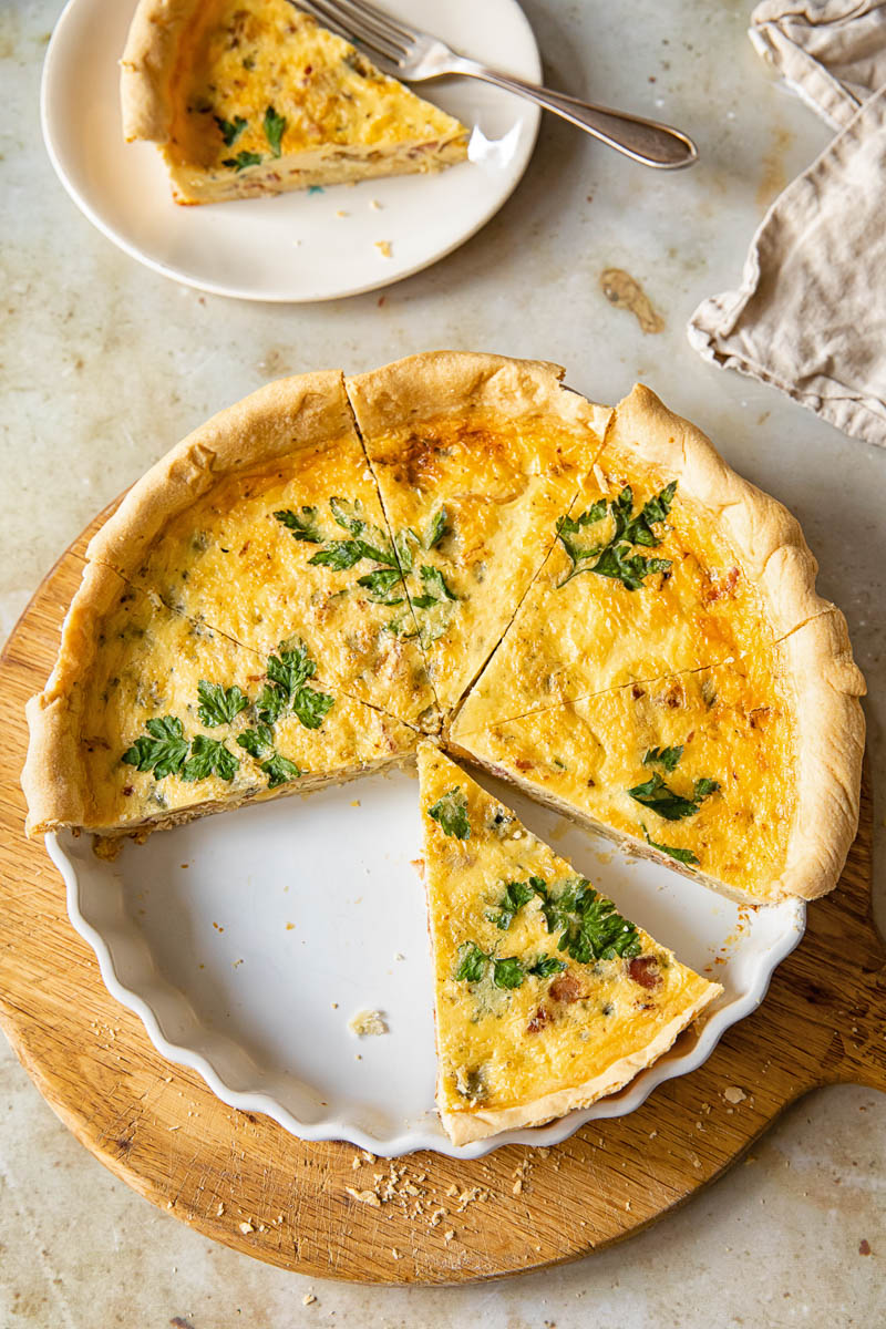 top down view of a quiche cut into slices with one slice takes out