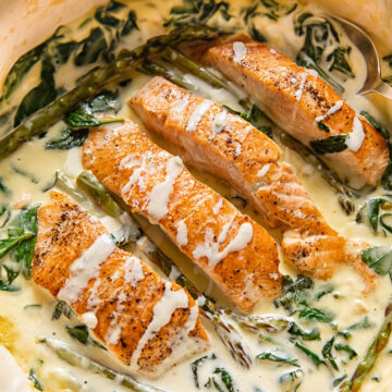 top down view of salmon florentine in a pan