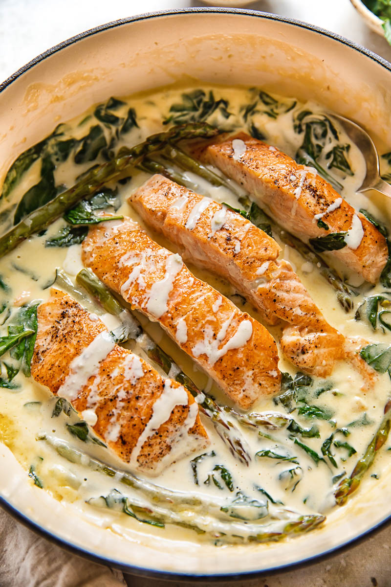 top down view of salmon florentine in a pan