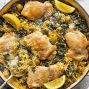 top down view of a round pan with lemon chicken and orzo bake