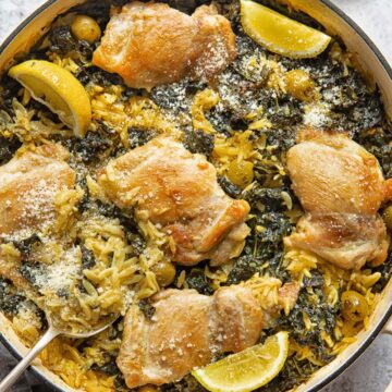 top down view of a round pan with lemon chicken and orzo bake