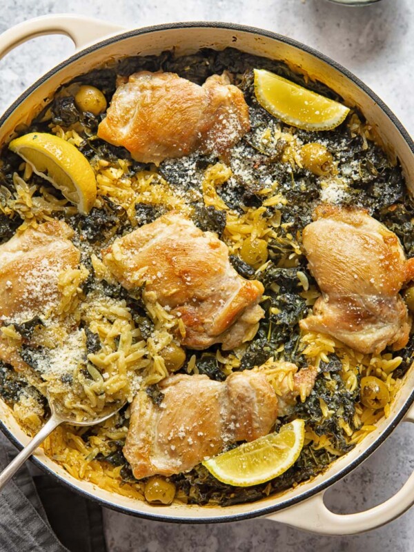top down view of a round pan with lemon chicken and orzo bake