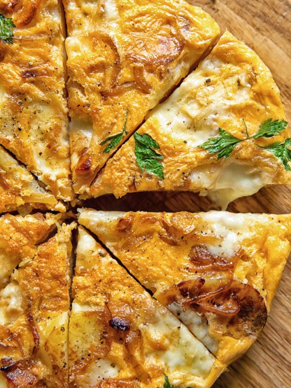 partial view of frittata cut into wedges