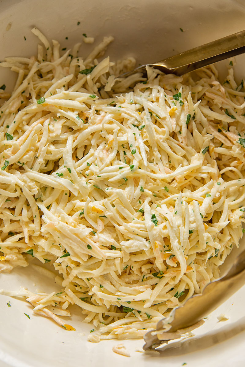 close up of grated celeriac slaw in a bowl