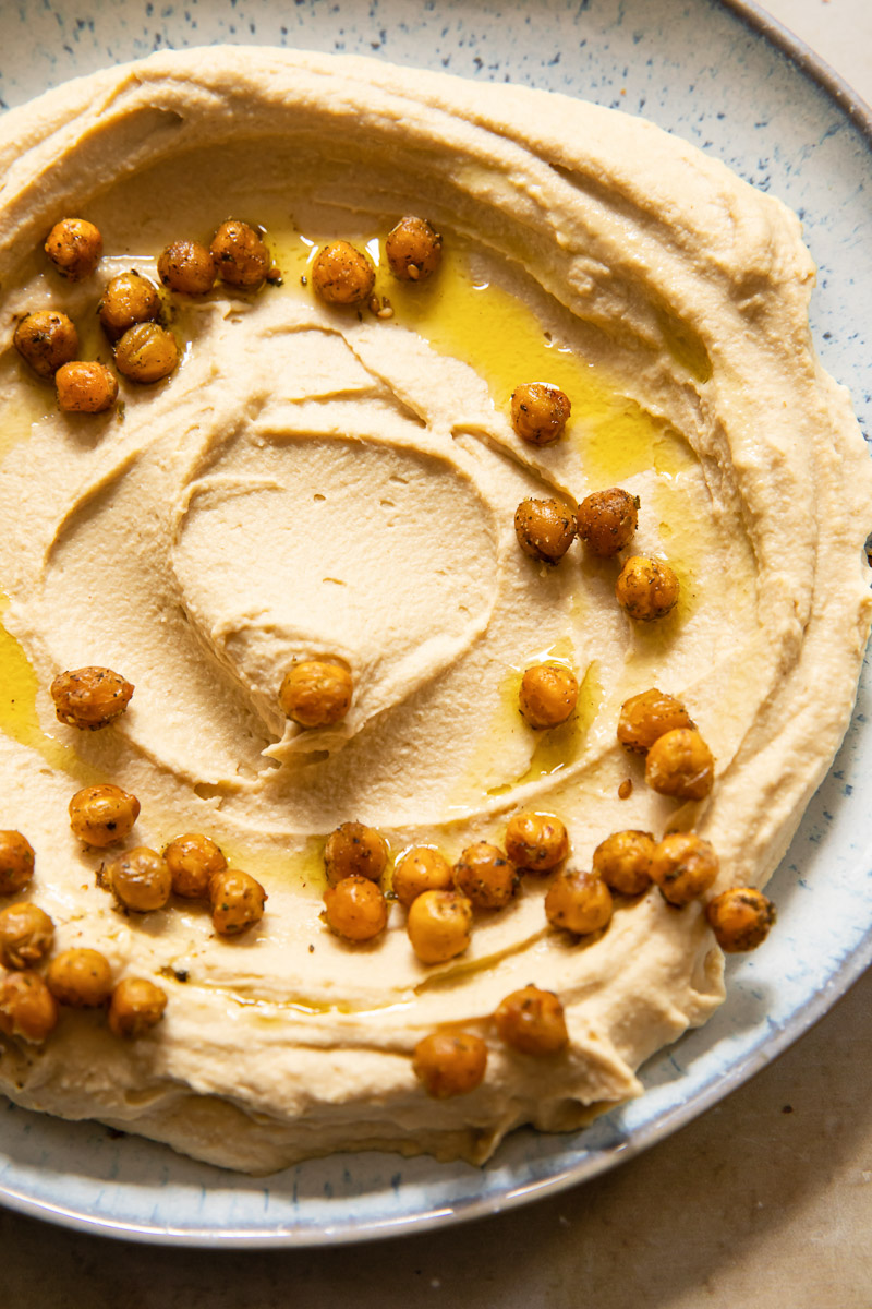 top down view of hummus topped with roasted chickpeas and olive oil