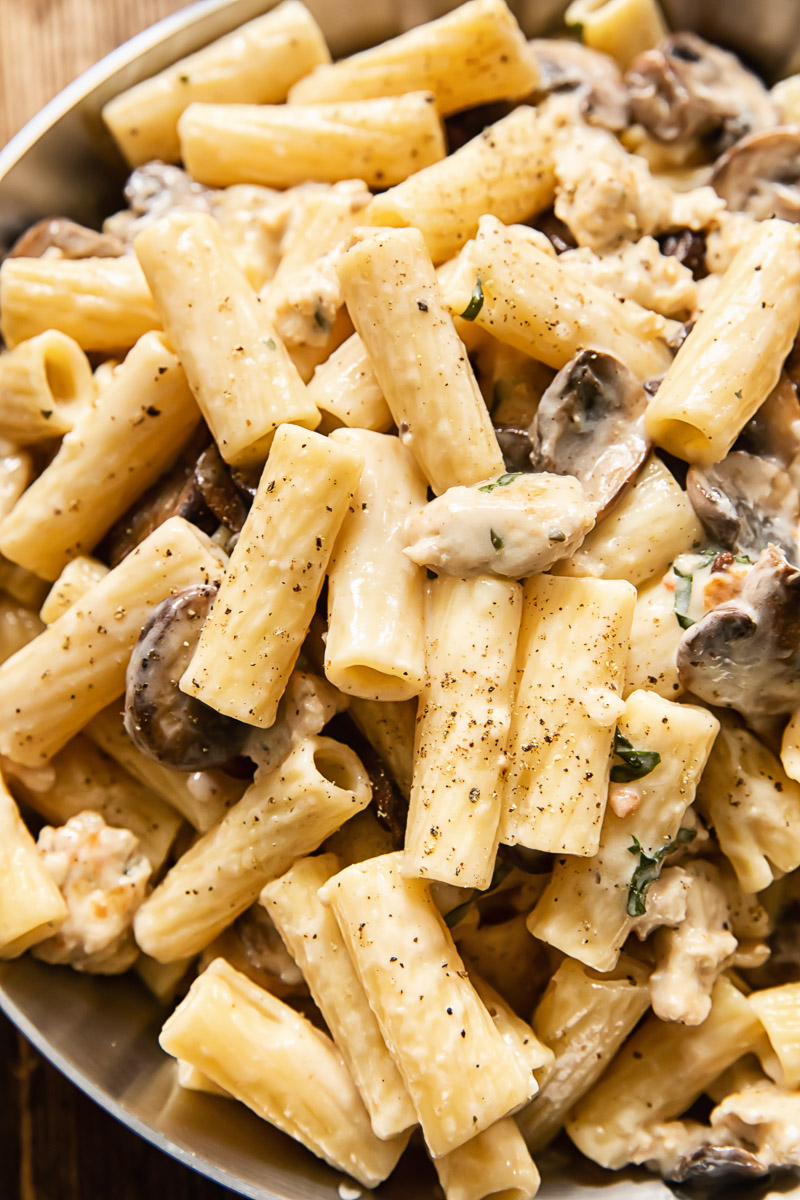 close up of rigatoni in a creamy sauce with mushrooms