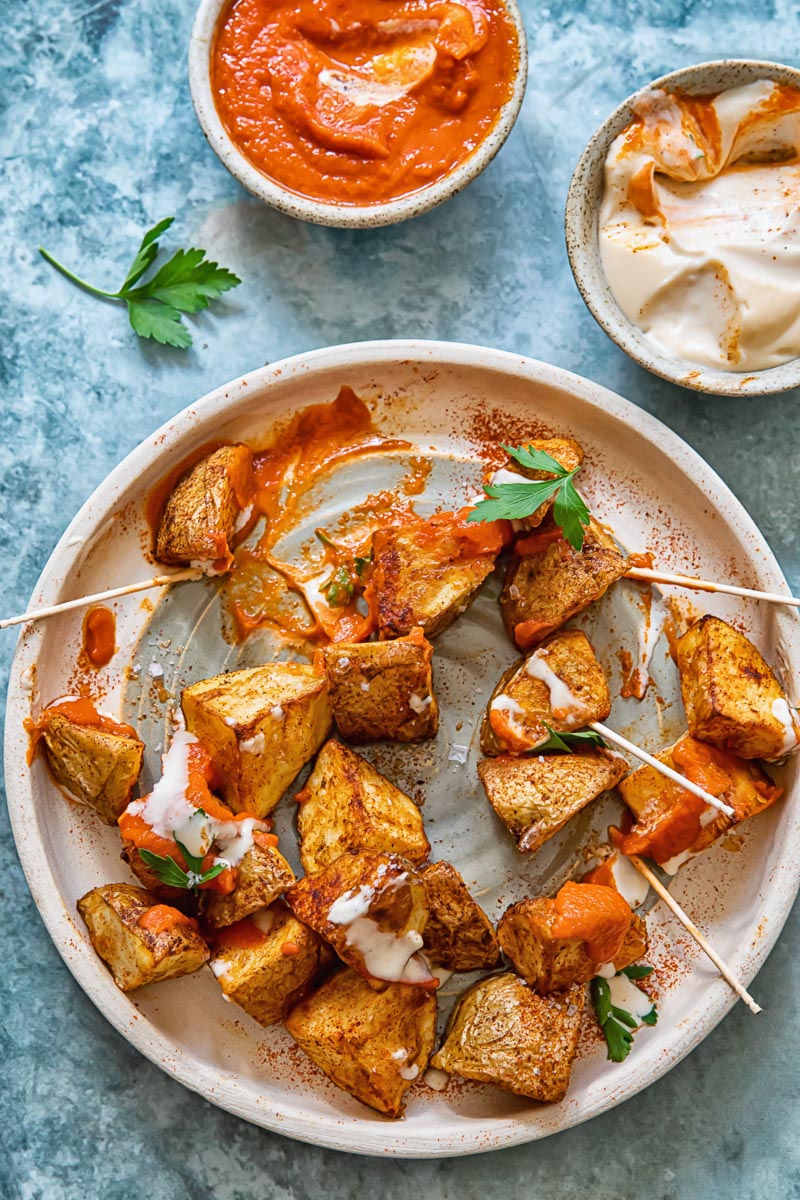 half eaten plate of patatas bravas