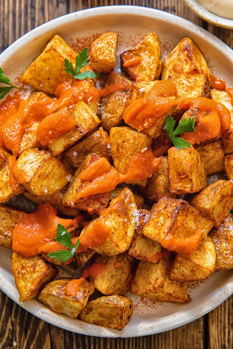 top down view of patatas bravas on a plate