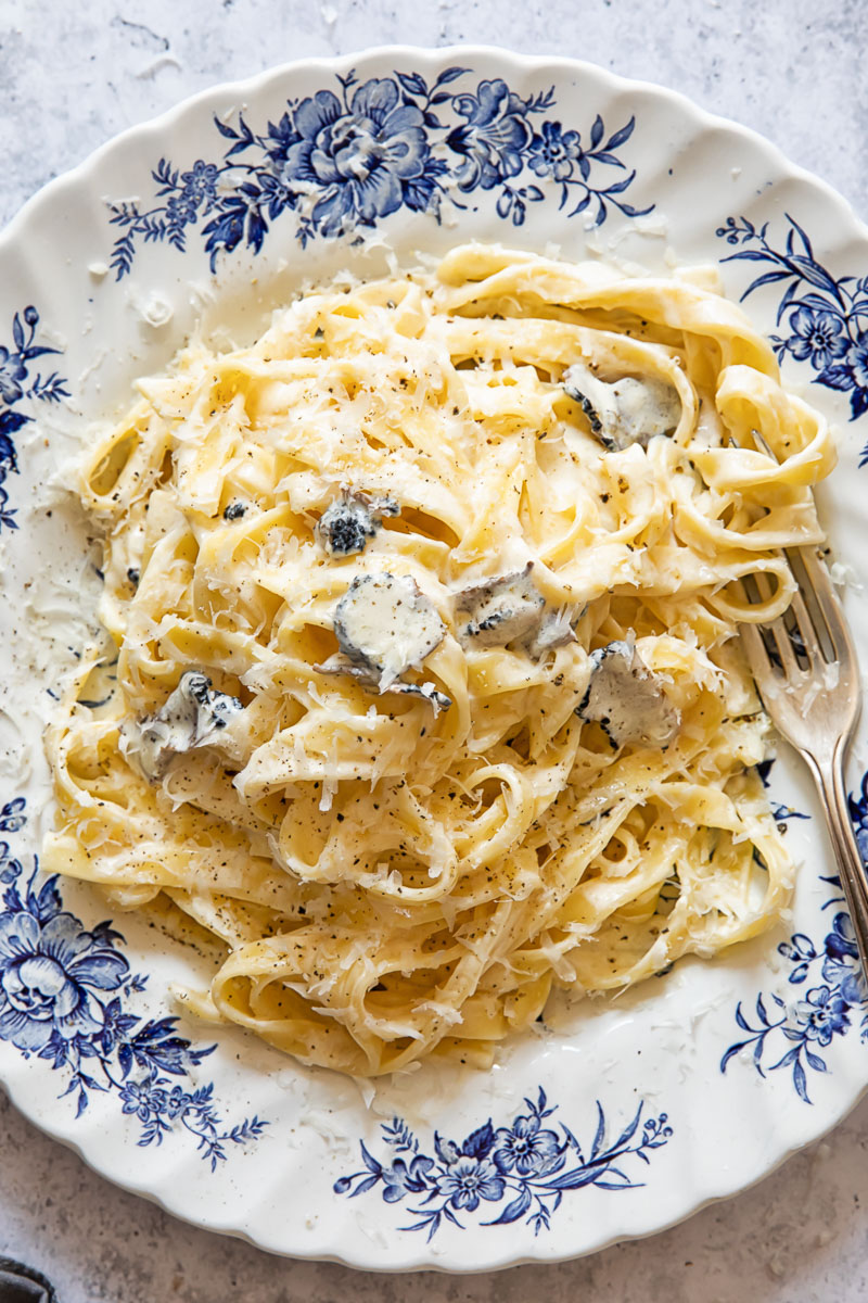 Top down view of tagliatelle pasta with truffle sauce on a plate