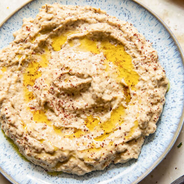 top down view of baba ganoush spread on blue plate