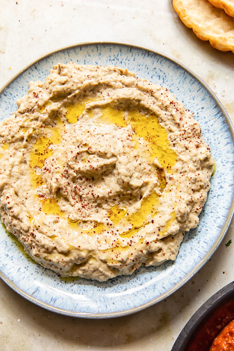 top down view of baba ganoush spread on blue plate