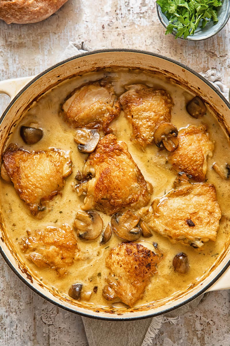 Top down view of chicken fricassee in a white pan
