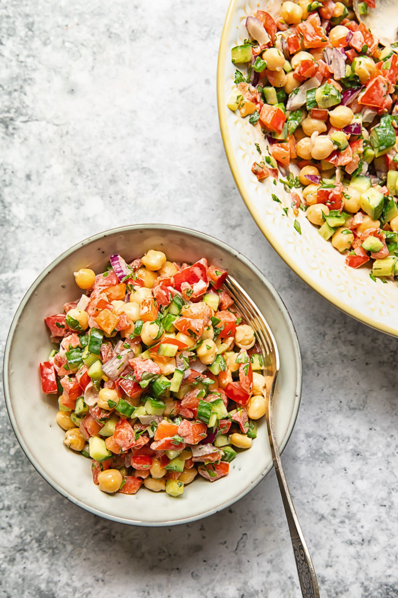 Top down view of Israeli salad in a bowl with a spoon