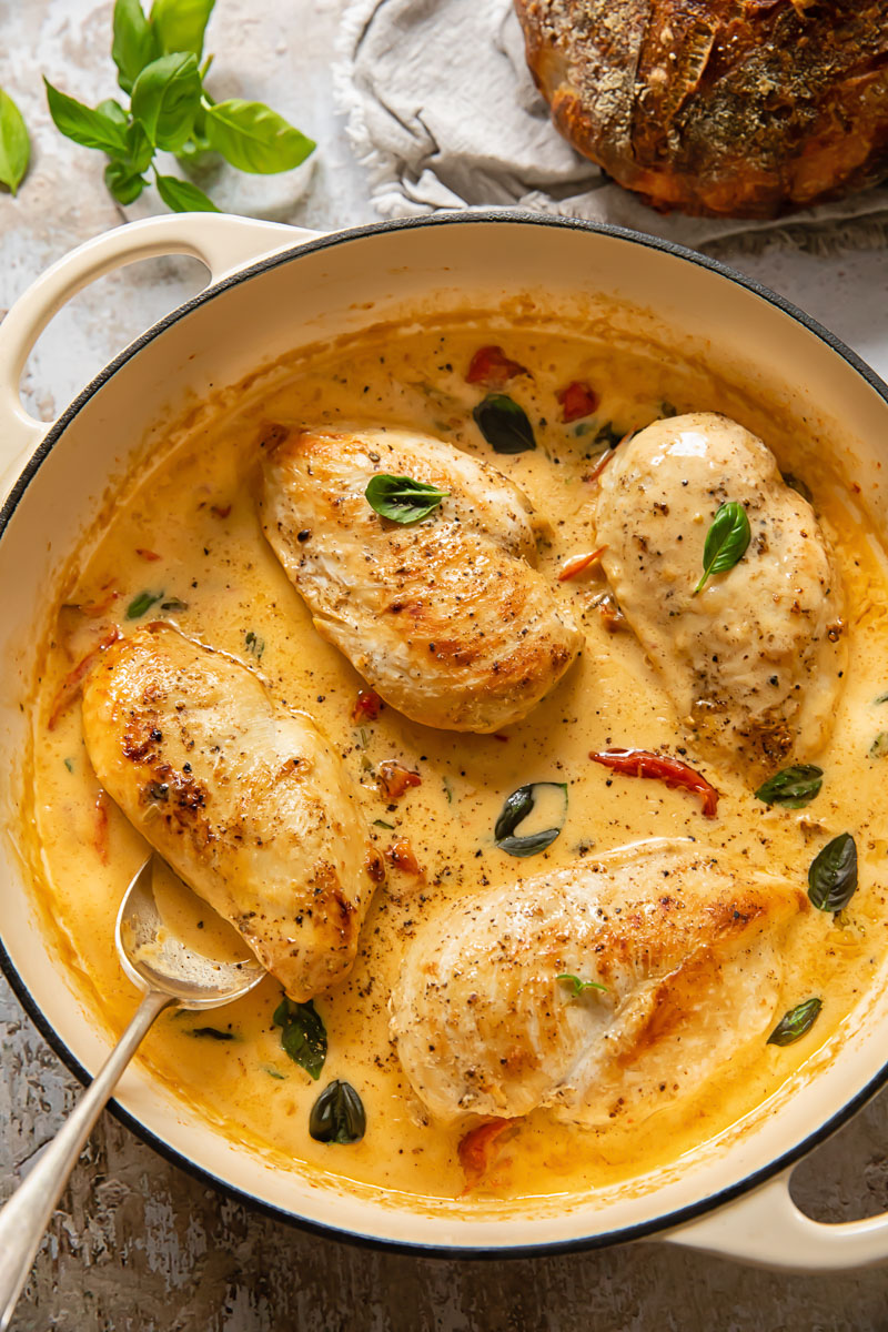 Top down view of marry me chicken with a spoon in a pan