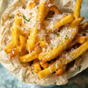 Top down view of truffle fries in a bowl sprinkled with parmesan