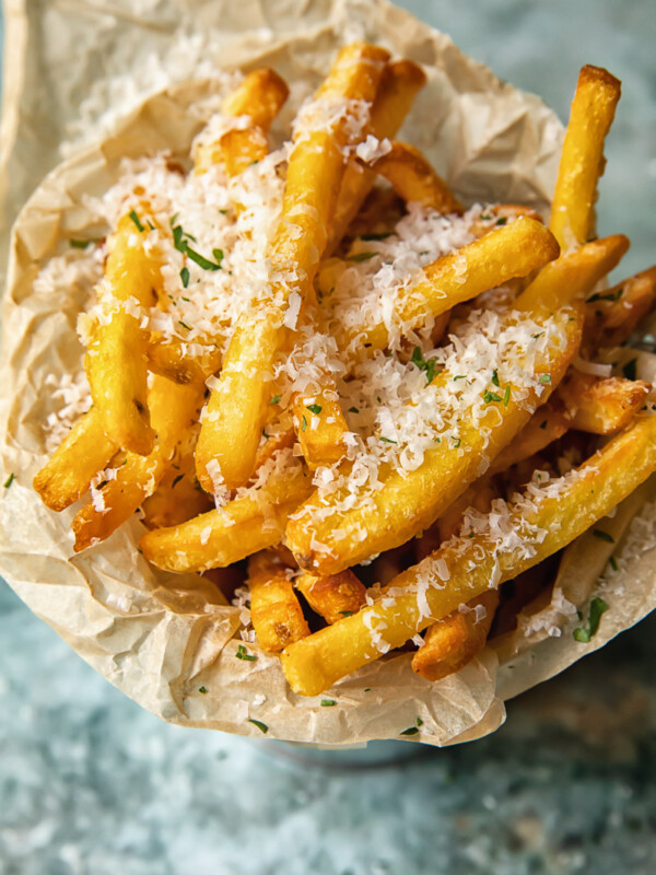 Top down view of truffle fries in a bowl sprinkled with parmesan