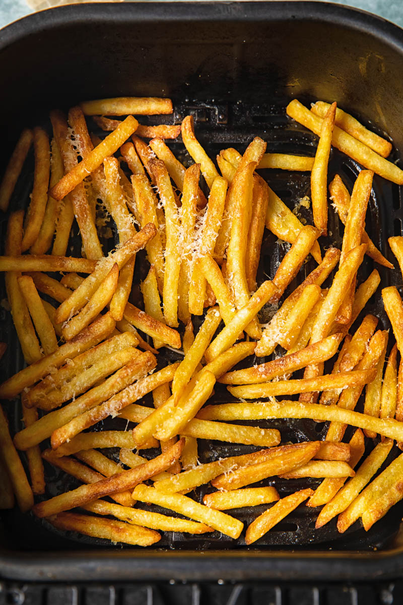 Process shot of parmesan truffle fries in air fryer tray