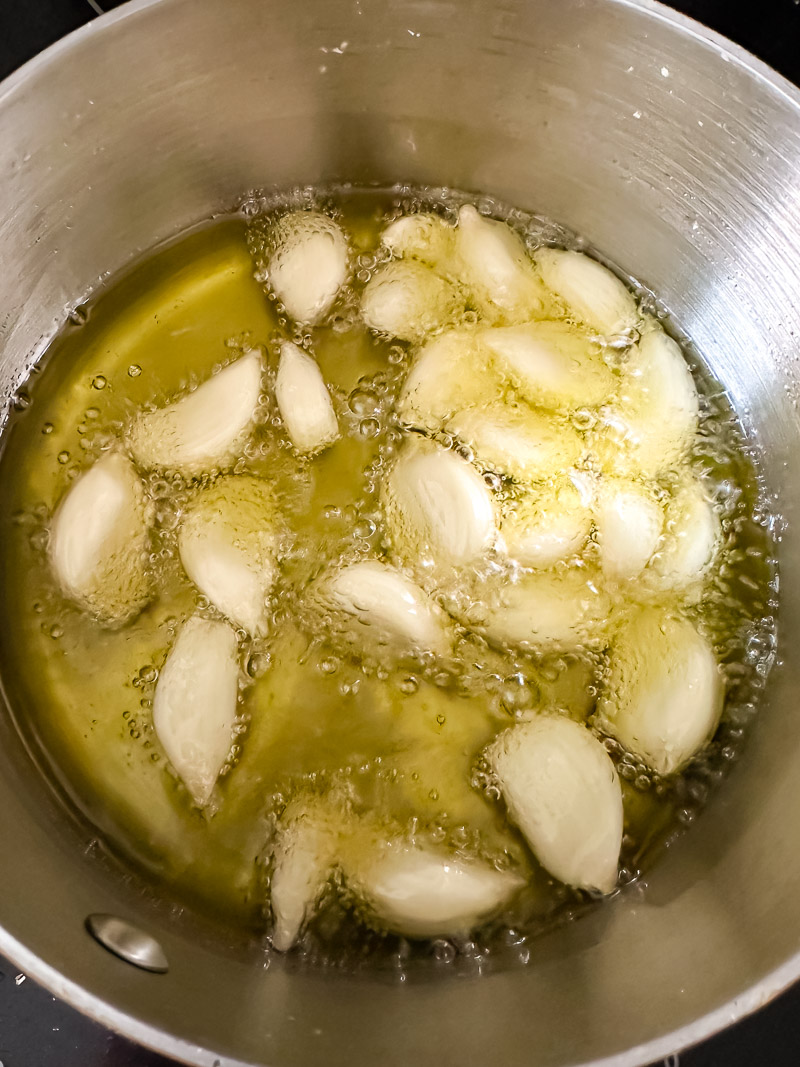 garlic cloves in sizzling olive oil in a pan