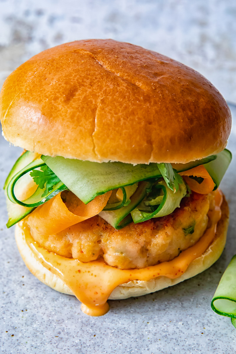 top down view of salmon burger with carrot cucumber slaw