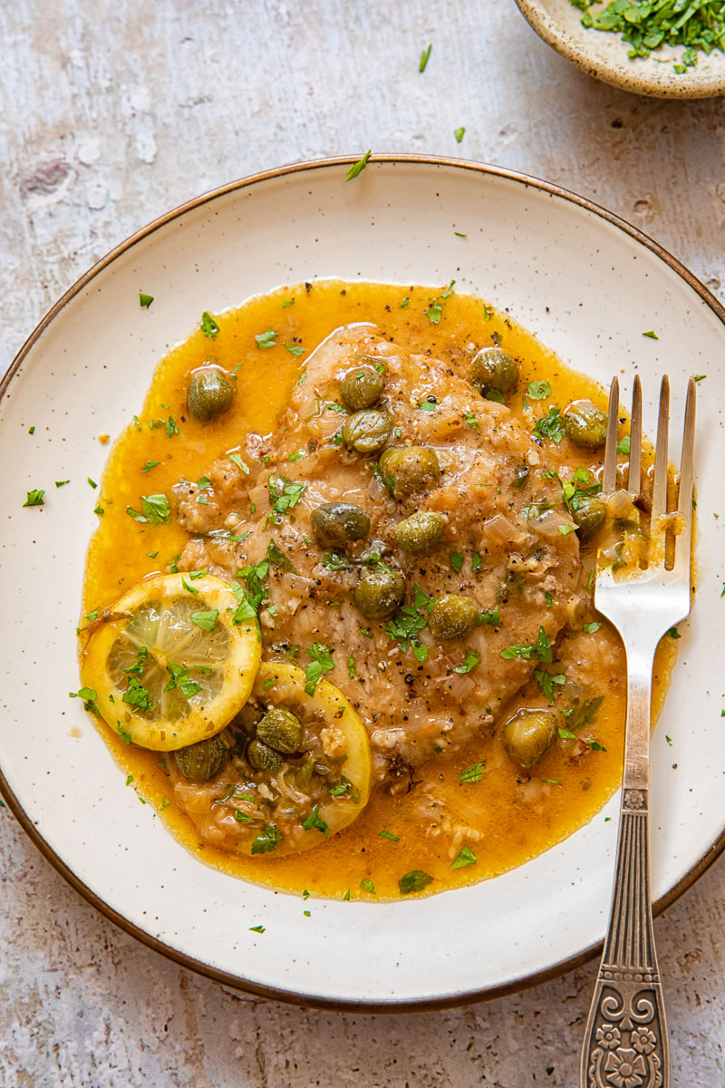 veal scallopini on a plate with a fork