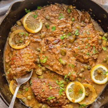 top down view of veal cutlets in lemon caper sauce