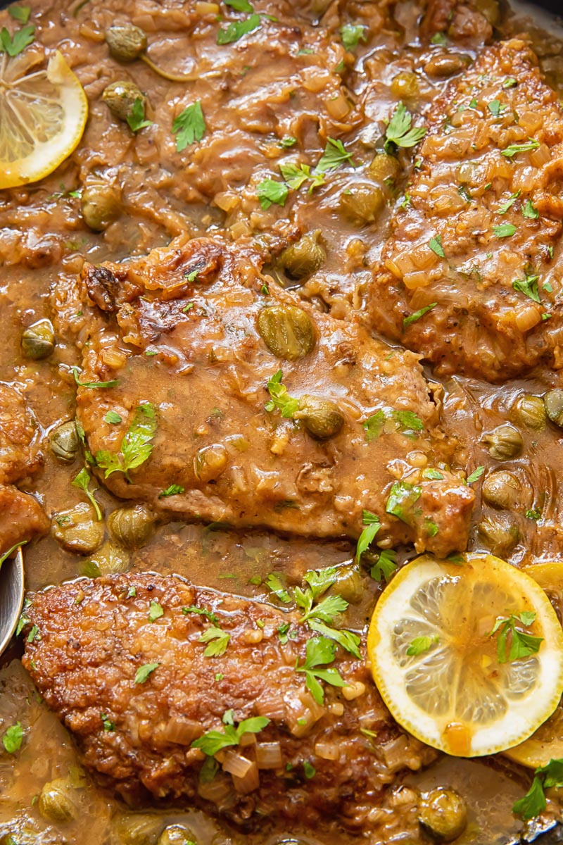 close up of veal escalope in lemon caper sauce