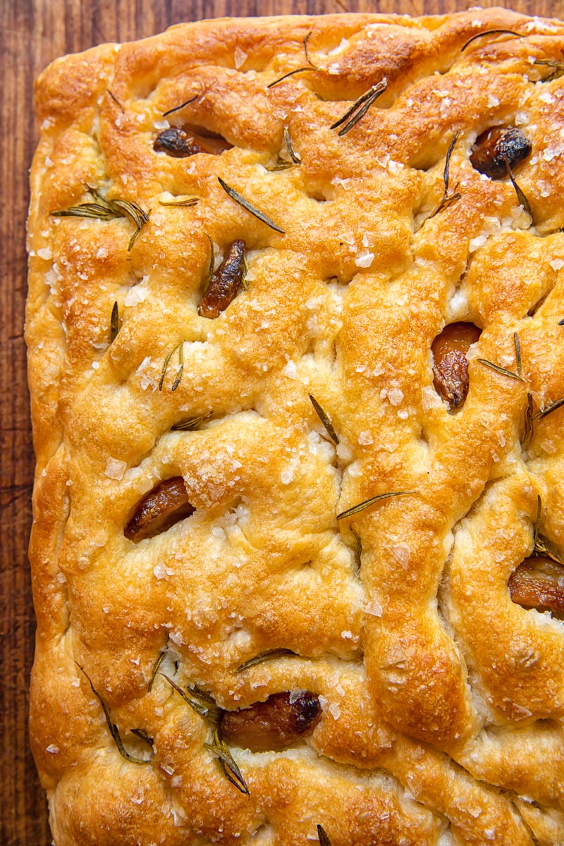 top down view of focaccia with garlic confit embedded into the bread.