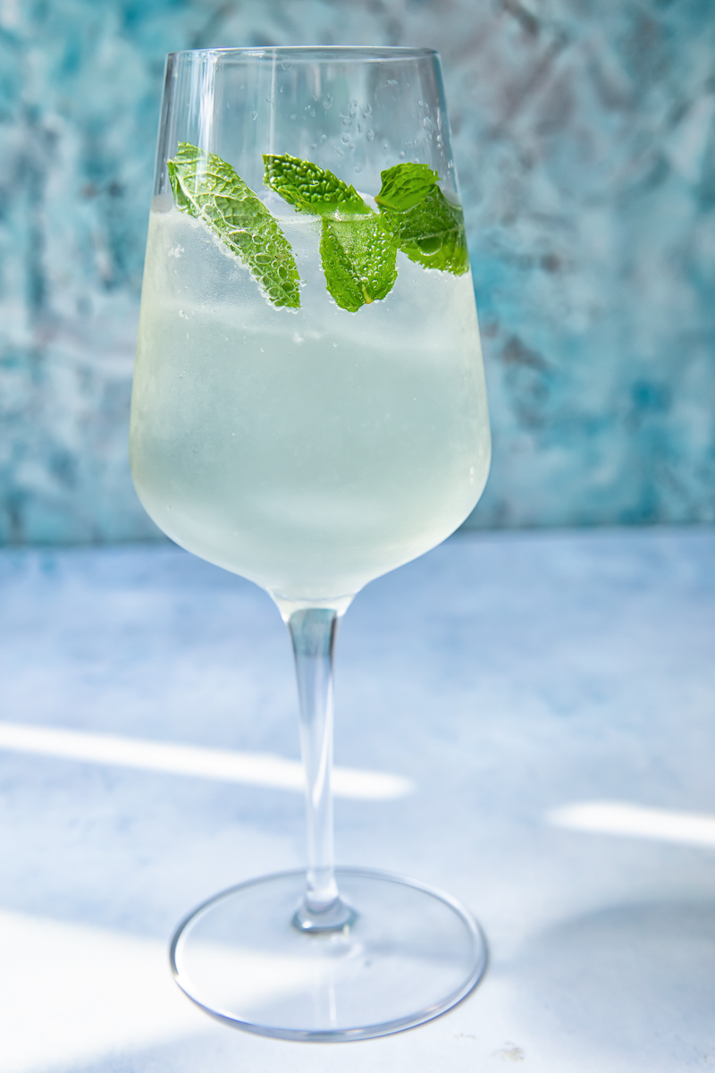 Side shot of mojito spritz in a glass with mint leaves