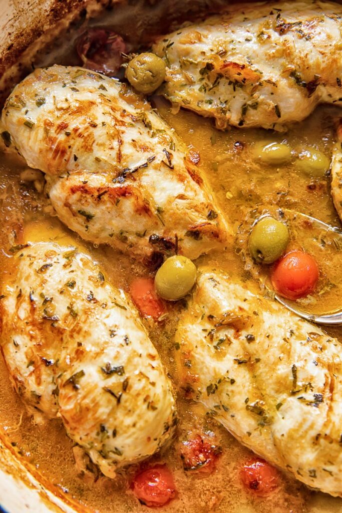 close up of chicken provencal with olives and cherry tomatoes visible