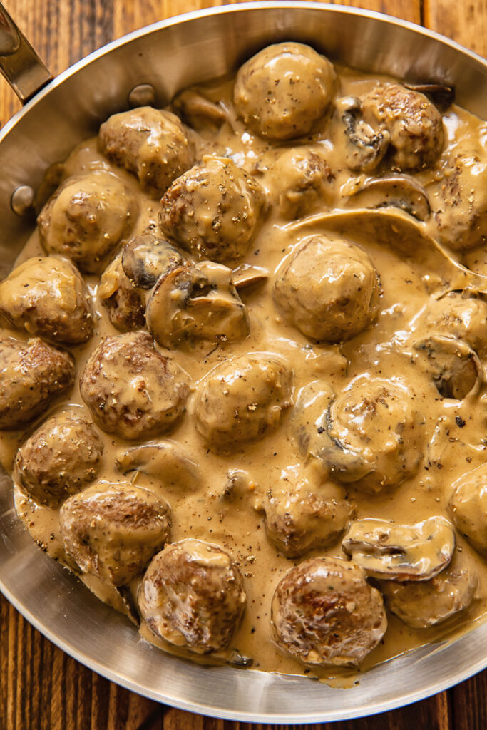 Top down view of meatballs in Marsala sauce in a pan