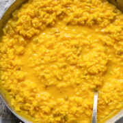 top down view of a pan of yellow saffron risotto
