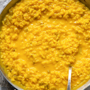 top down view of a pan of yellow saffron risotto