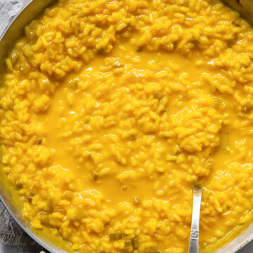 top down view of a pan of yellow saffron risotto