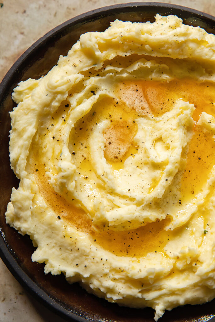 Close up of mashed potatoes with brown butter on top