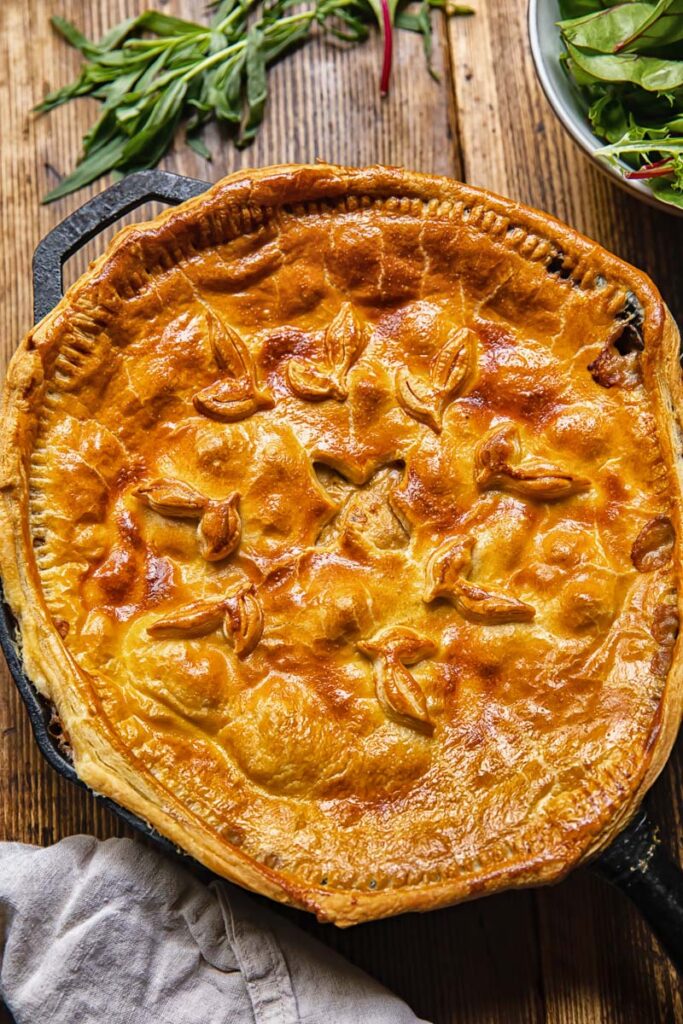 Top down view of a baked chicken and mushroom pie