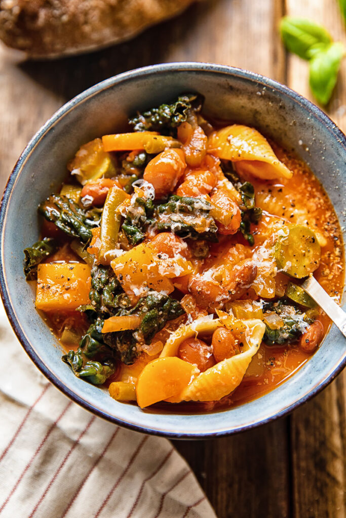 Bowl of minestrone soup with a spoon