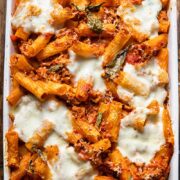 Top down view of pasta al forno topped with melted cheese is a baking dish
