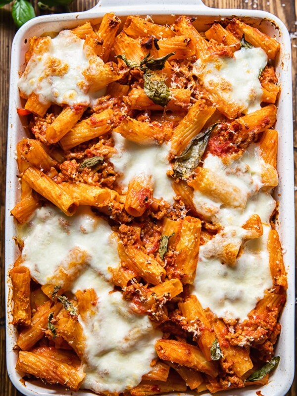 Top down view of pasta al forno topped with melted cheese is a baking dish