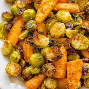 close up of a serving plate with roasted brussels sprouts and carrots