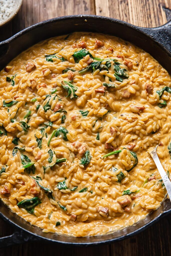 Close up shot of chorizo and spinach orzo in a pan
