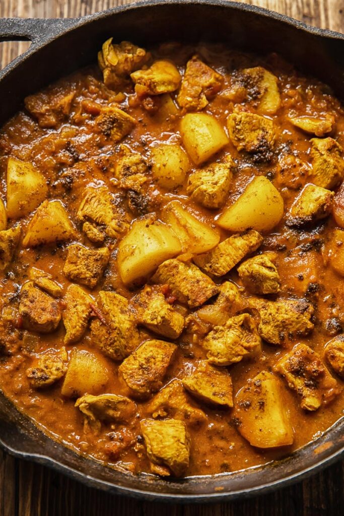 Close up shot of chicken curry with potatoes in a pan