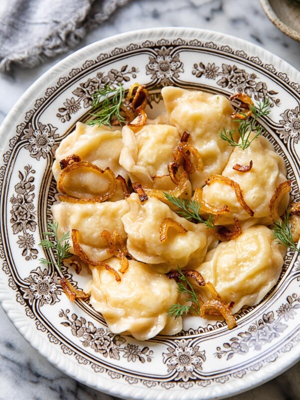 bowl of potato vareniki with onions and dill