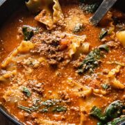 close up of a pot of lasagna soup with a ladle inside