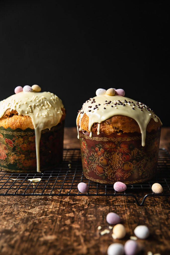 two Easter breads glazed with white chocolate on dark background