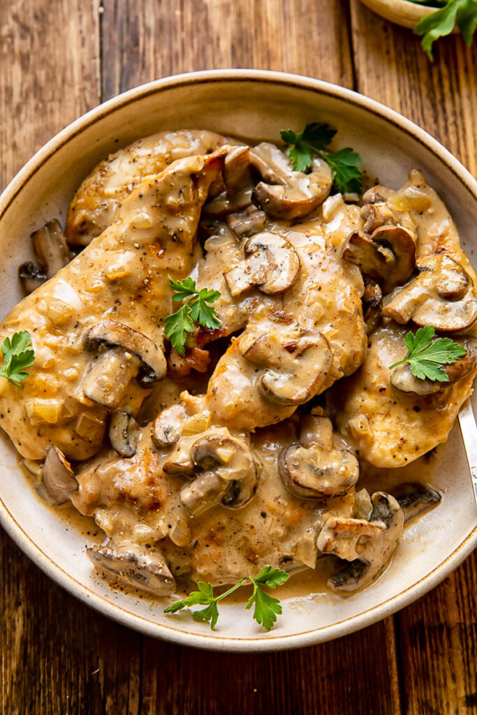 chicken and mushroom marsala in a brown bowl