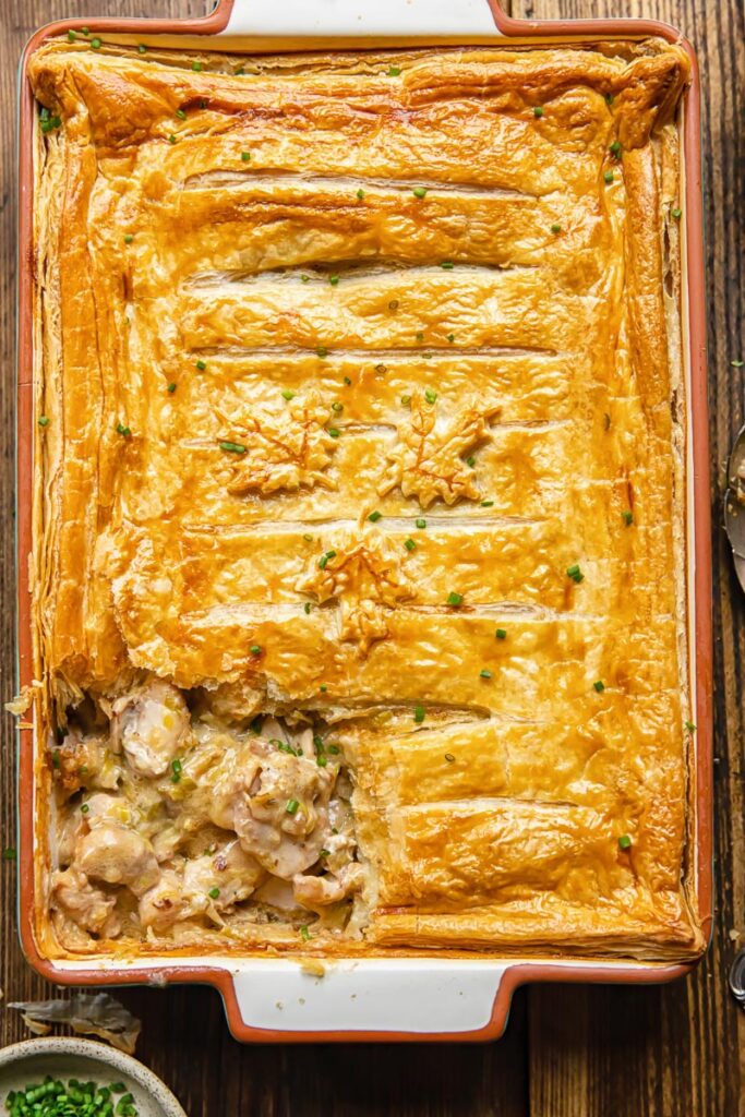 Top down shot of chicken and leak pie in a ractangular baking dish