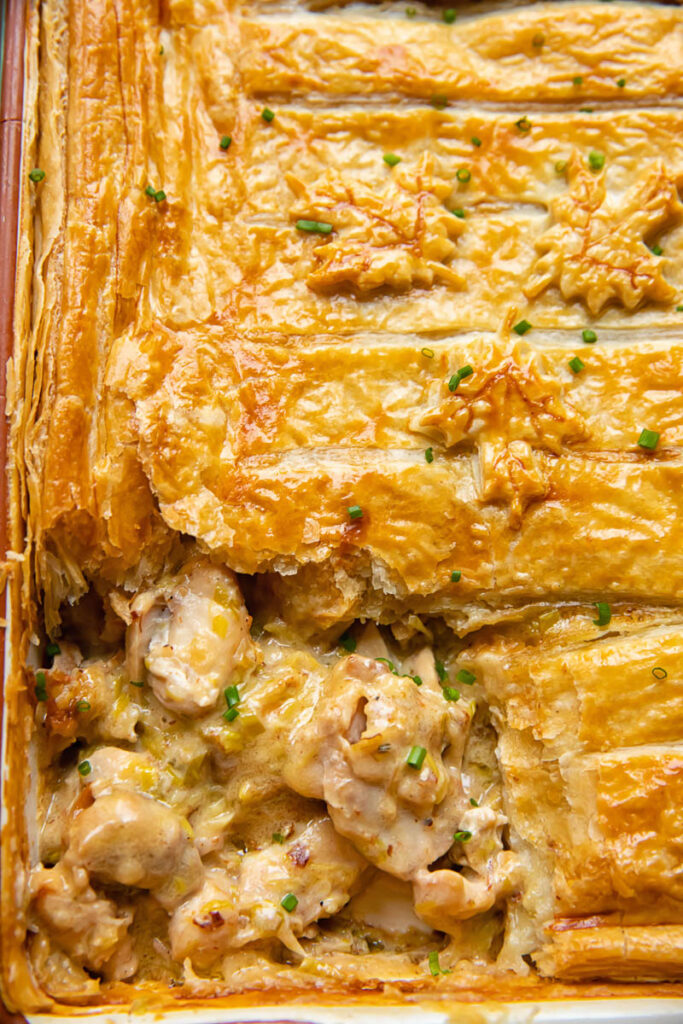 Close up shot of chicken and leek pie with a slice removed from a corner