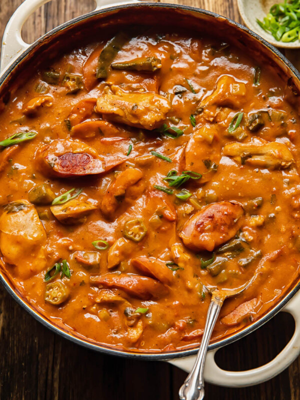 Chicken and sausage gumbo in a large pot with okra peppers and celery