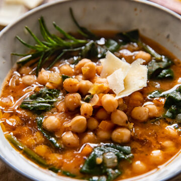 Bowl of Tuscan chickpea soup with rosemary and hard cheese